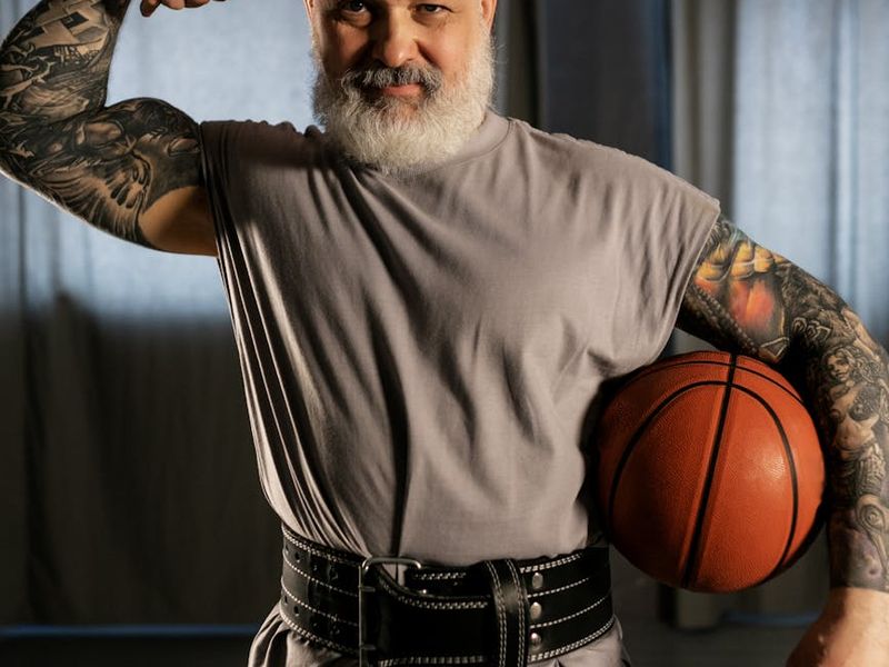 A man mid-exercise, showing focus and determination in a well-lit space.