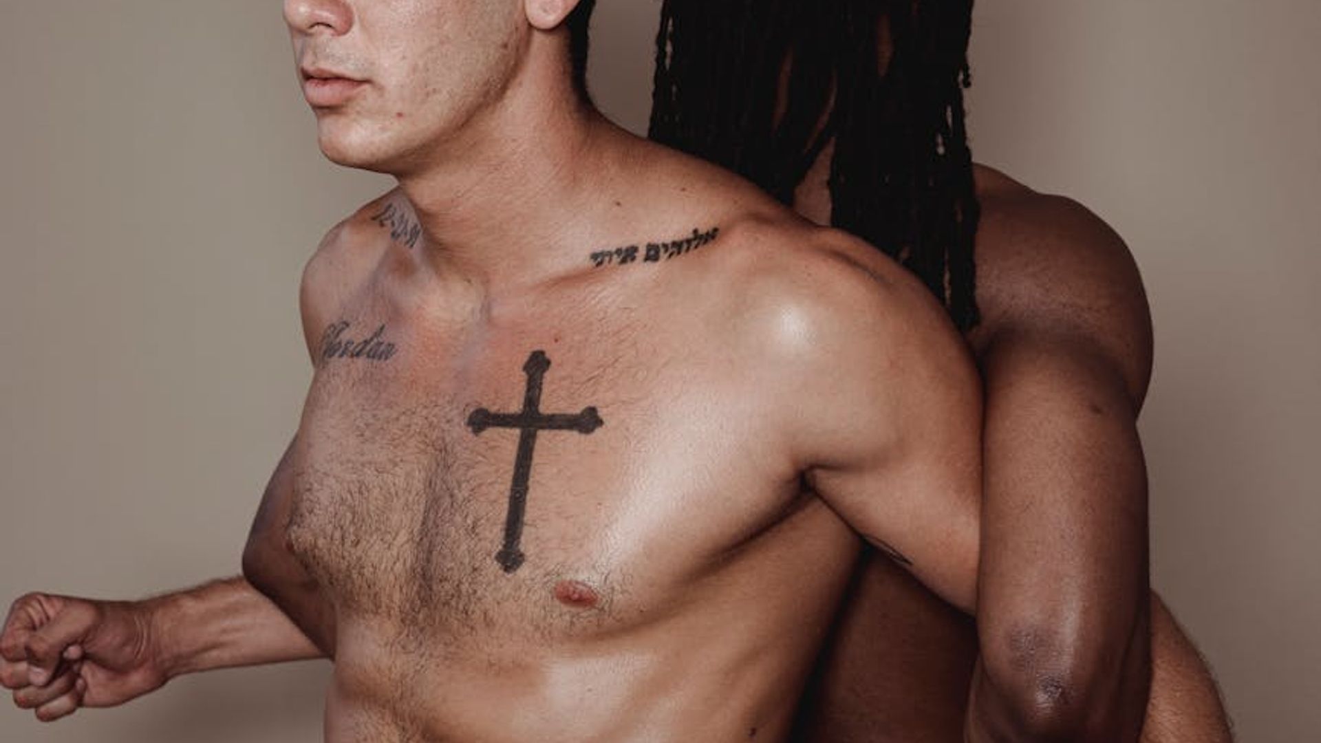 Man performing a controlled strength exercise in a minimalist dark gym.